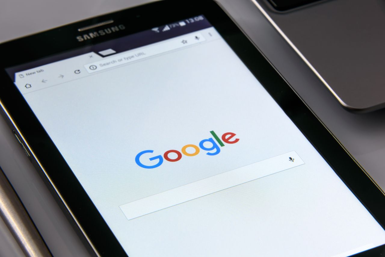 A close-up view of a tablet showing Googles search page, highlighting technology and web browsing.